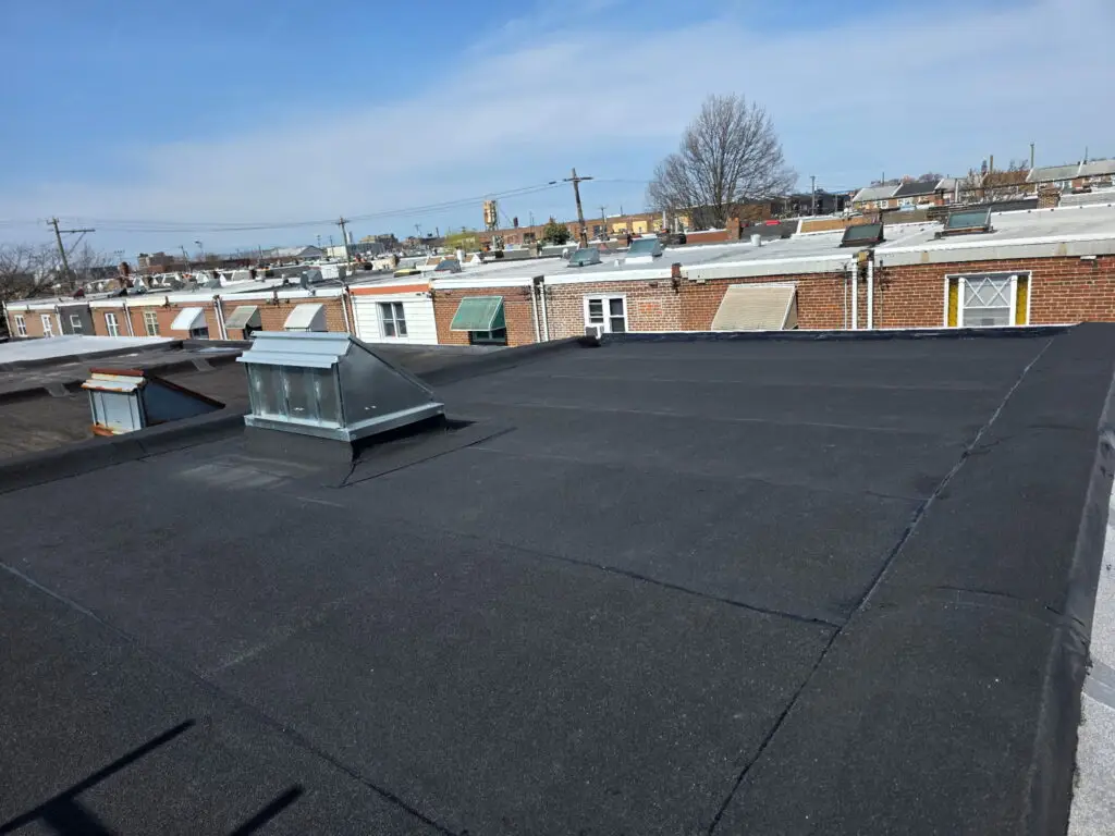 Aerial view of completed flat rubber roof on Philadelphia row homes — Discounted Roofing LLC