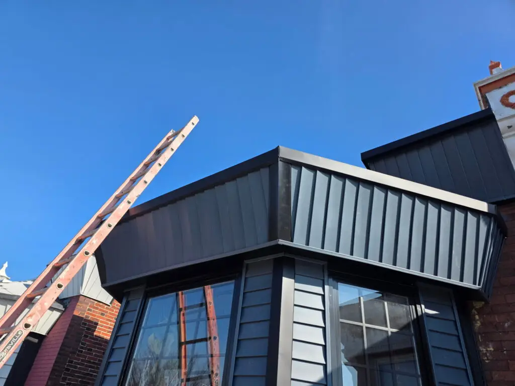 Black metal standing seam roof with bay window installation — Discounted Roofing LLC Philadelphia