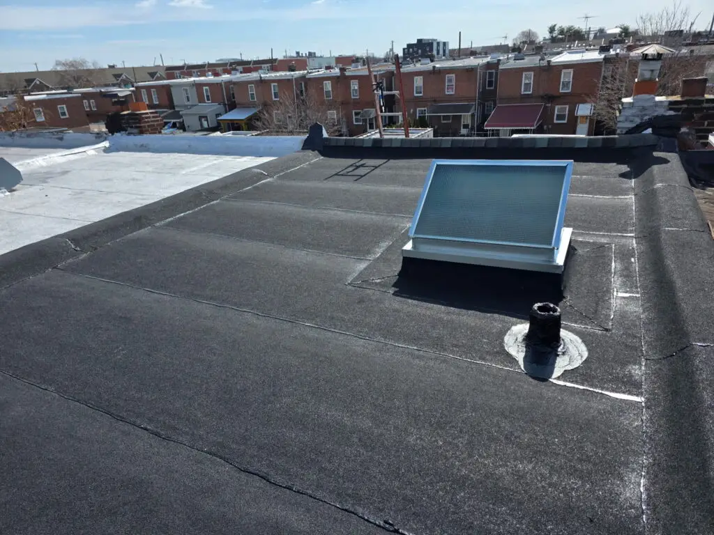 Flat rubber roof with skylight and vent pipe, Philadelphia — Discounted Roofing LLC